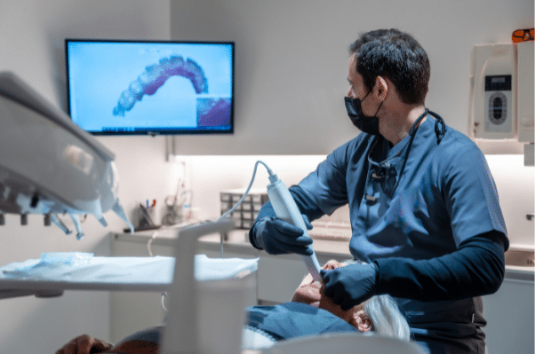 A dental professional in Sacramento using a handheld 3D scanner on a patient to create a virtual anatomical model.