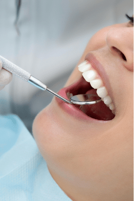 A dentist performing a targeted clinical evaluation on a specific tooth to diagnose a dental emergency or infection.
