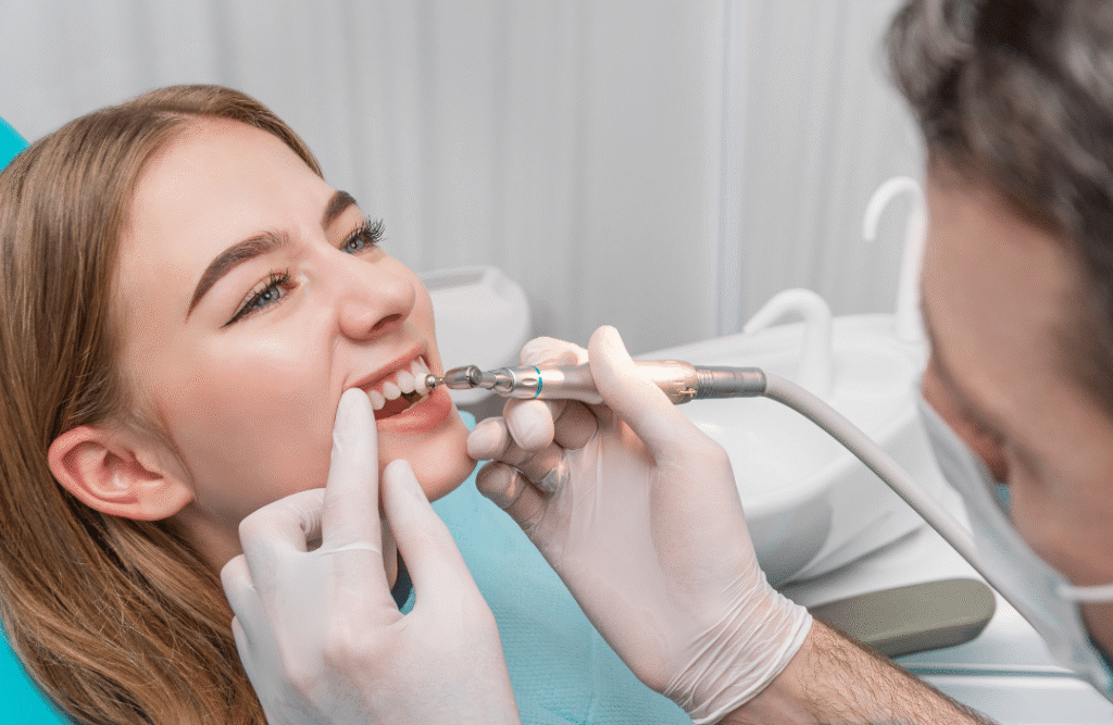 A female patient receiving a specialized periodontal maintenance cleaning from a dental professional to manage gum health and deep pockets.
