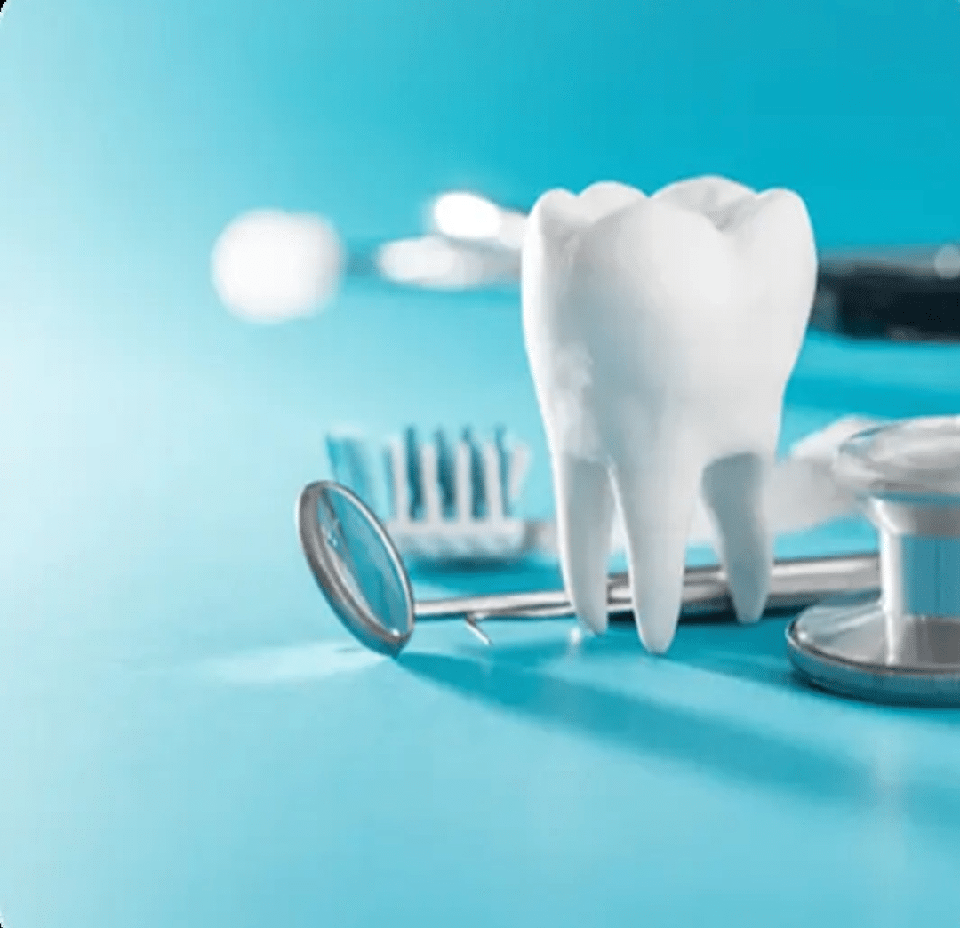 A clinical display of a large white tooth model next to a dental mirror and stethoscope, representing the restorative uses of dental bonding.