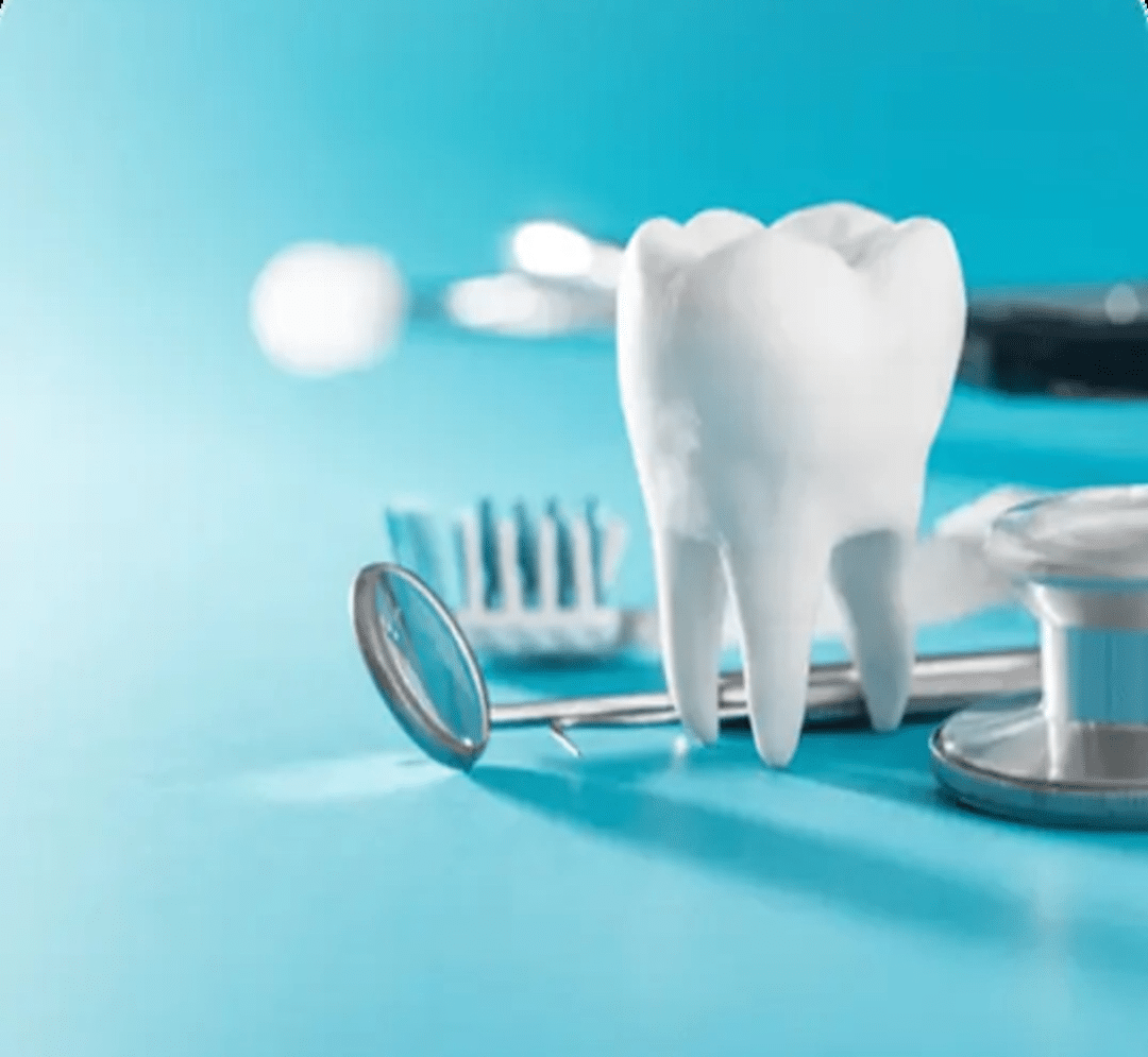 A clinical display featuring a white tooth model alongside a dental mirror and a stethoscope, highlighting the focus on restorative dental health.
