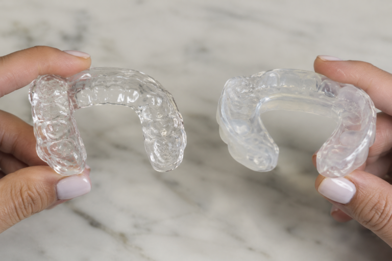 A custom night guard and a TMJ stabilization splint side by side.